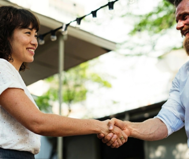 Service tech and happy customer shaking hands